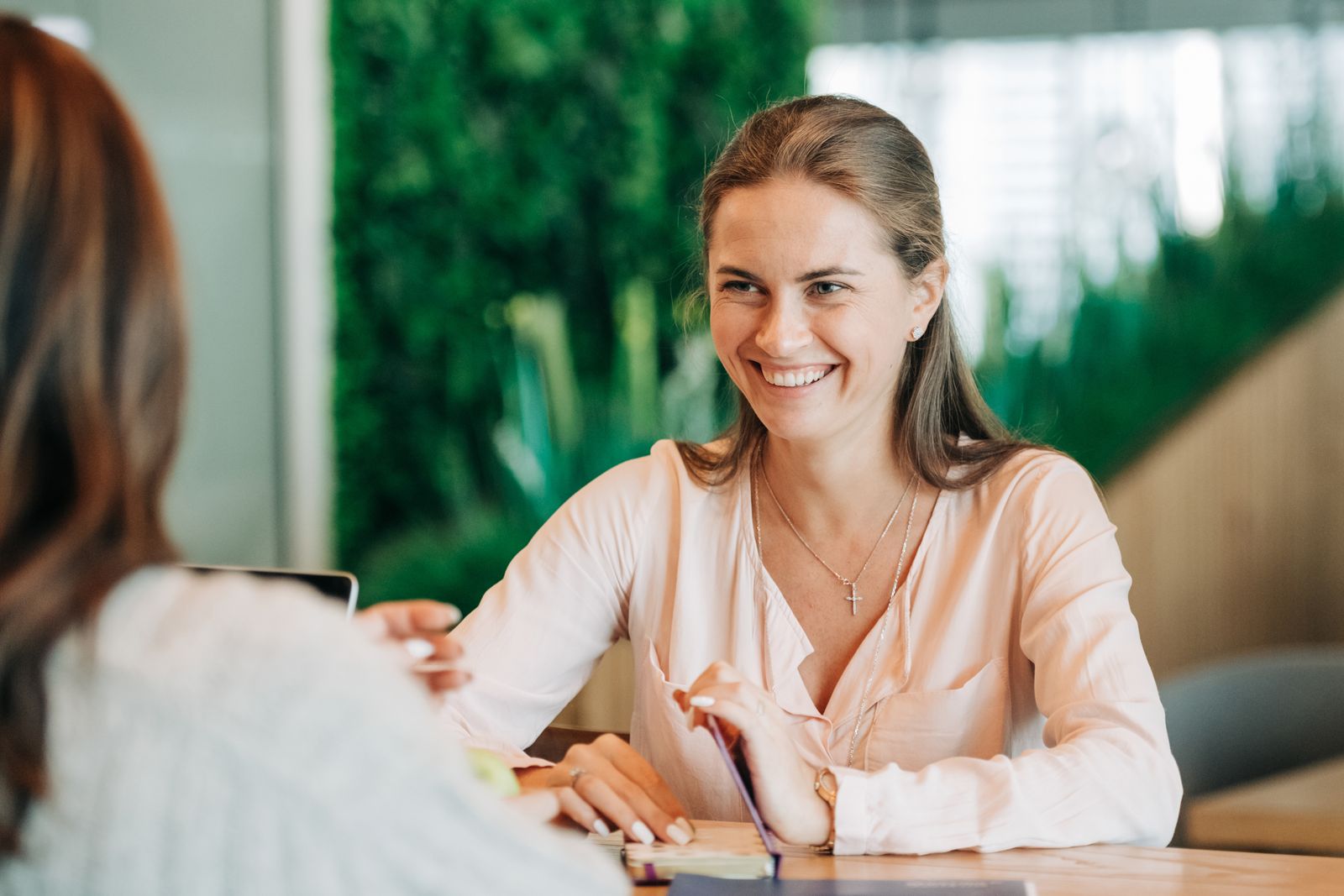 A young woman smiling during a conversation
