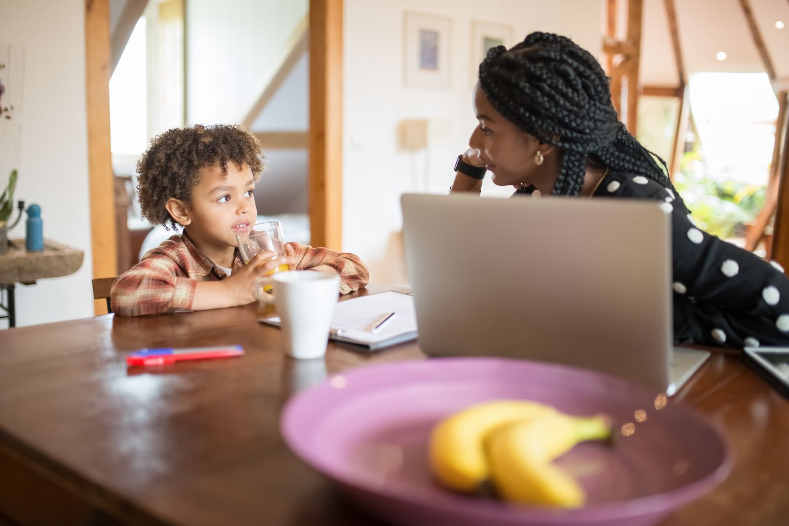A mother talking with her son at the kitchen table